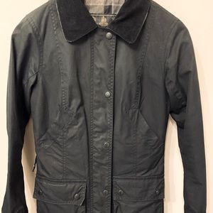 Barbour waxed cotton classic coat with tartan plaid lining. Size USA 4.